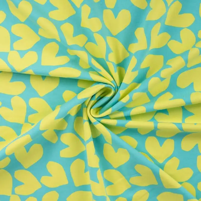 Tessuto French terry stampato con cuori gialli e blu