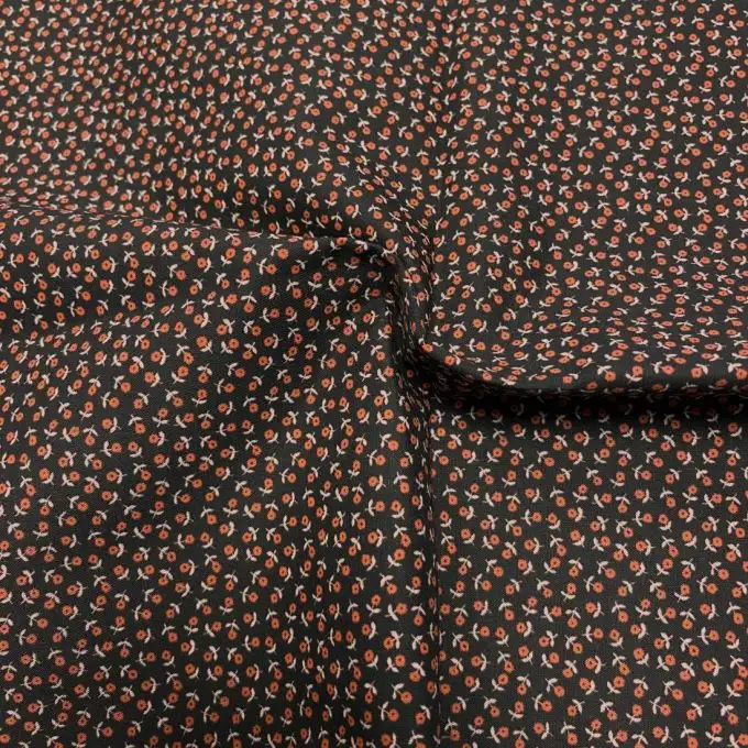 Tessuto voile di cotone morbido nero mini fiori rossi
