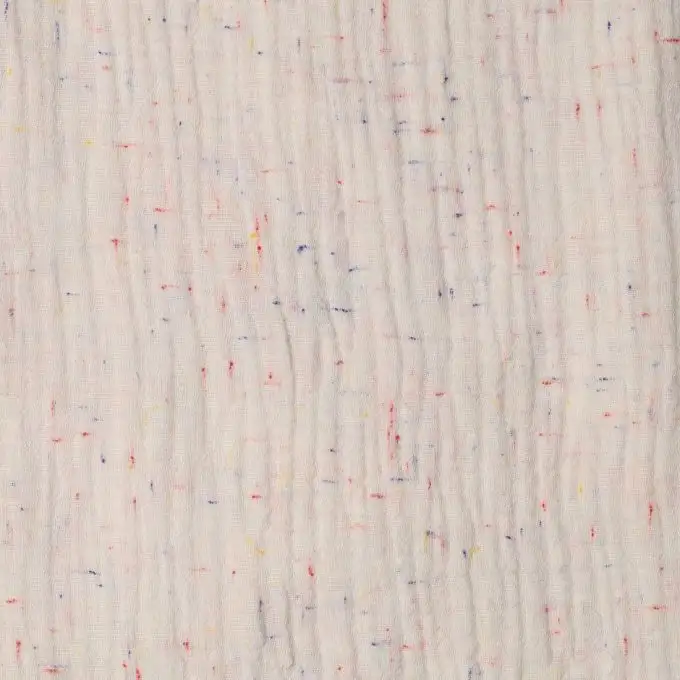 Tessuto in doppio garza misto biologico ecru maculato colorato