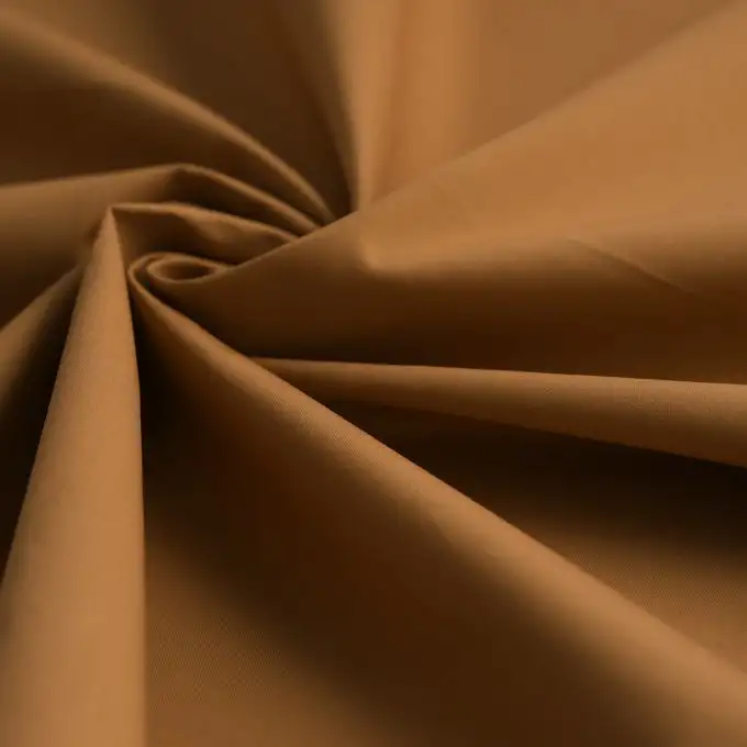 Tessuto popeline cotone caramello uniforme