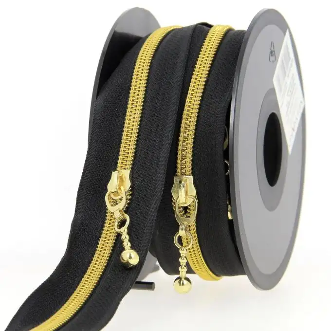 Chiusura lampo al metro nera e dorata + cursore
