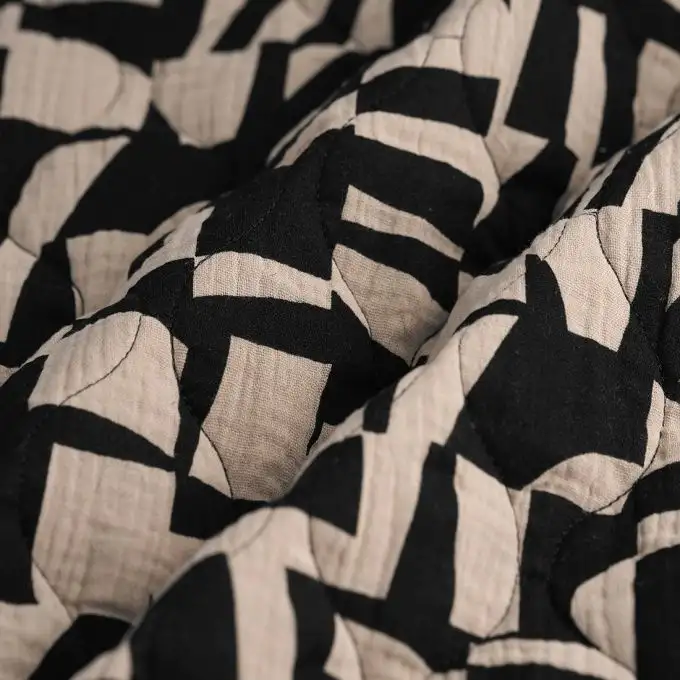 Tessuto trapuntato doppia garza geometrico nero talpa