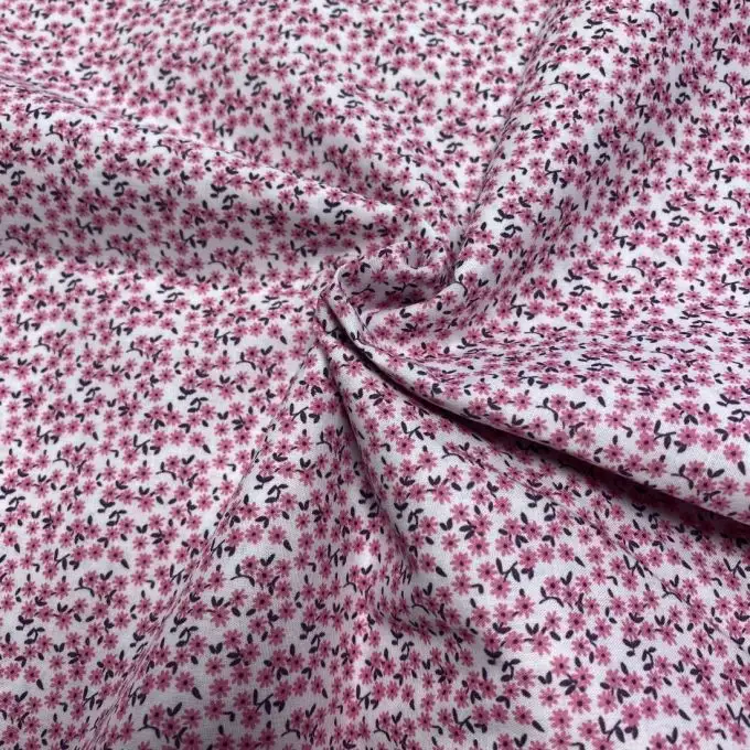 Tessuto voile di cotone morbido rosa confetto mini margherite dense