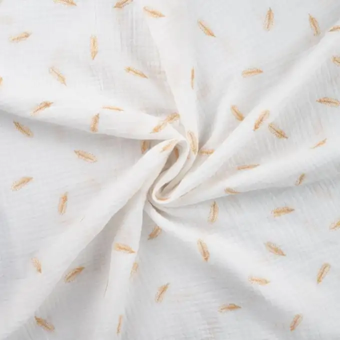 Tessuto doppio gaze ricamato oro piuma ecru