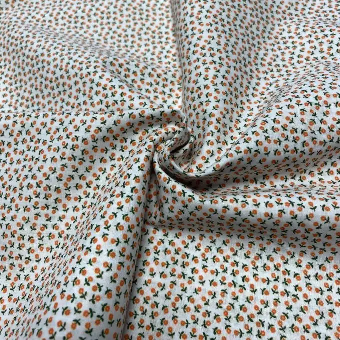 Tessuto voile di cotone morbido bianco mini fiori arancioni